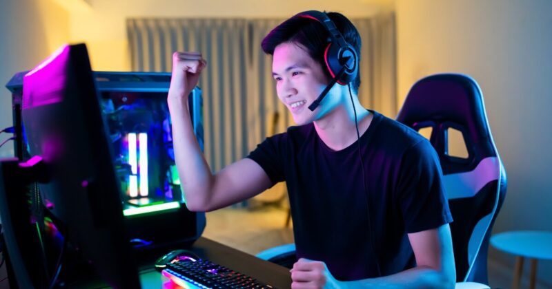 PCゲームで勝利し喜んでいる男性